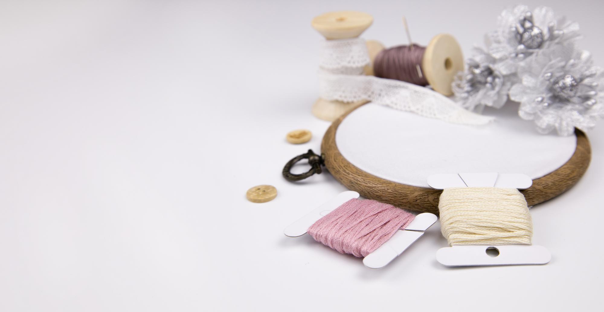 Workshop table with thread spools and a hoop